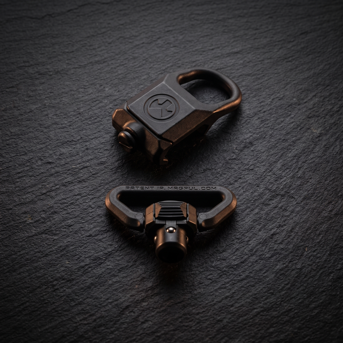 Magpul rail sling attachment and QD sling swivel in a flat lay, illustrating our guide to AR-15 upgrades under £100