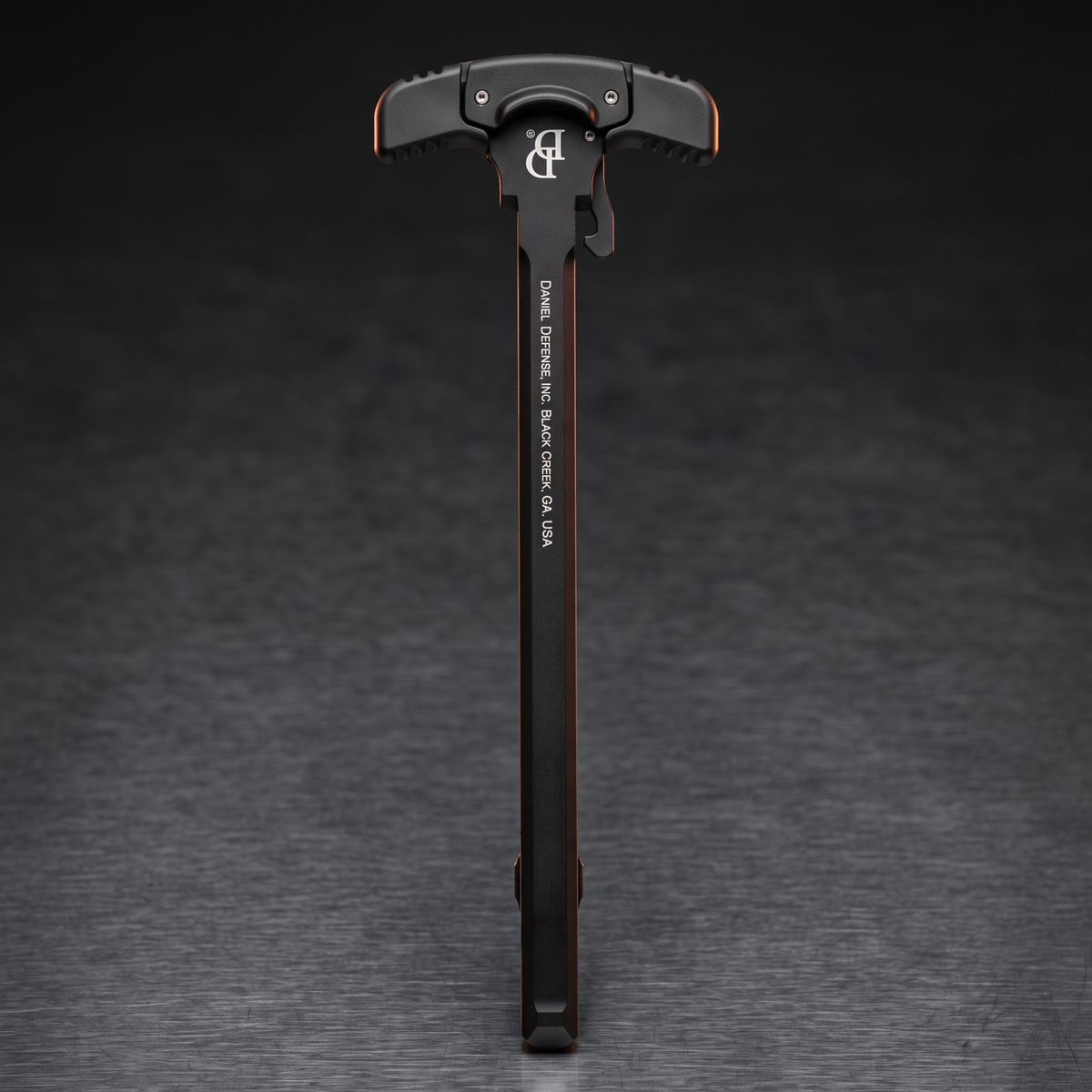 Charging Handles & Safety Selectors – Daniel Defense GRIP-N-RIP ambidextrous charging handle on a dark steel surface