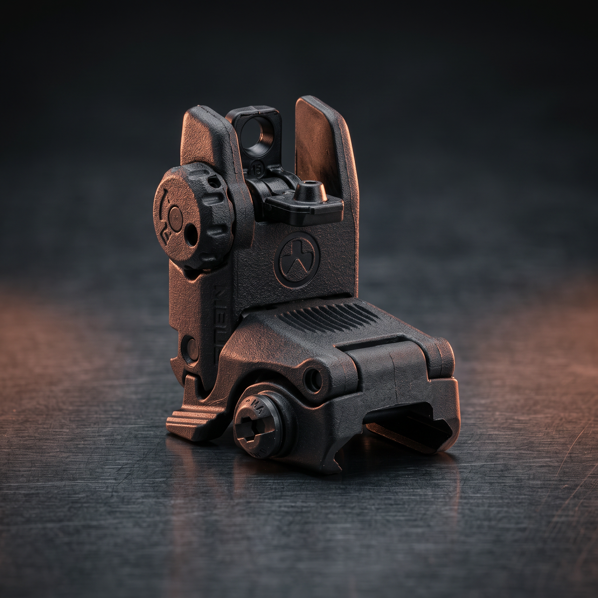 Iron Sights & Backup Sights – Magpul MBUS rear flip-up sight on a dark steel surface