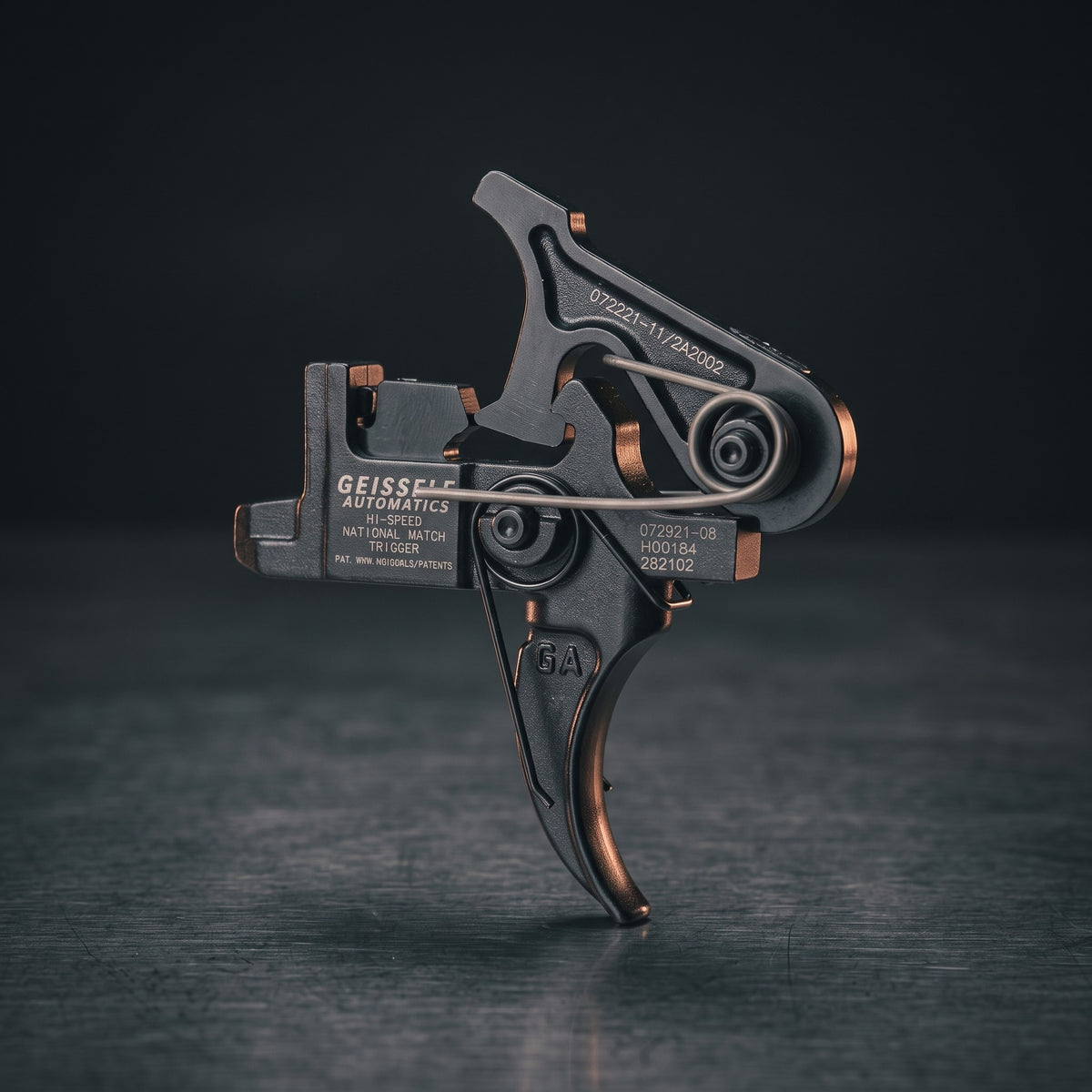 Two-Stage Rifle Triggers – Geissele Hi-Speed Match two-stage AR-15 trigger on a dark steel surface