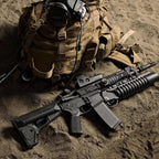 Magpul ACS Carbine Stock Mil-Spec for AR-15/M4, on a rifle laid on sand with kit