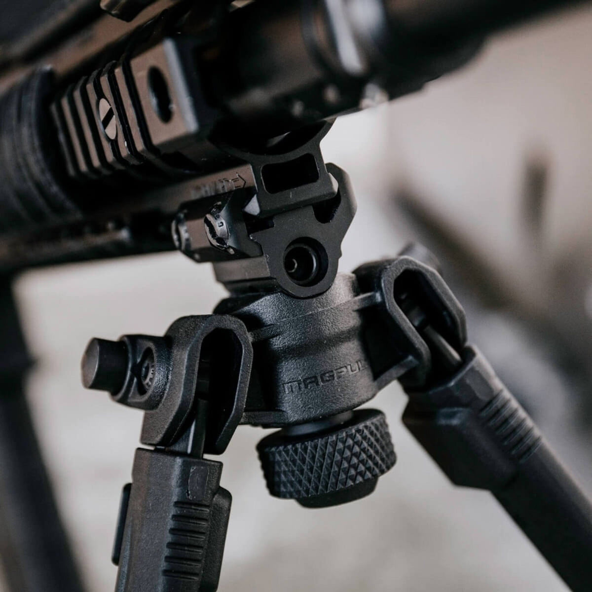 Magpul Bipod for 1913 Picatinny Rail, fitted under a rifle, close-up