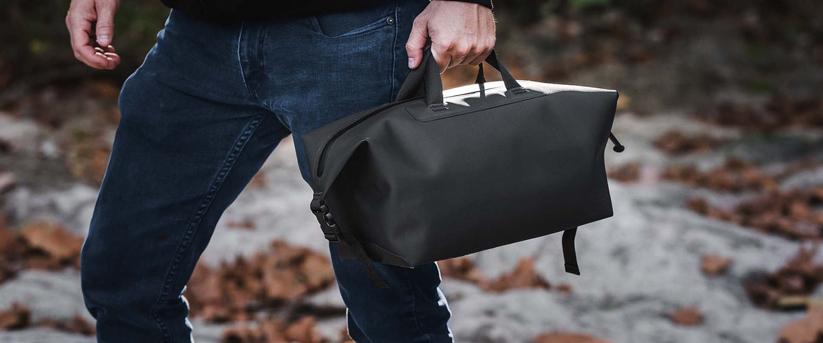 Magpul DAKA Takeout Bag Large, carried by hand outdoors