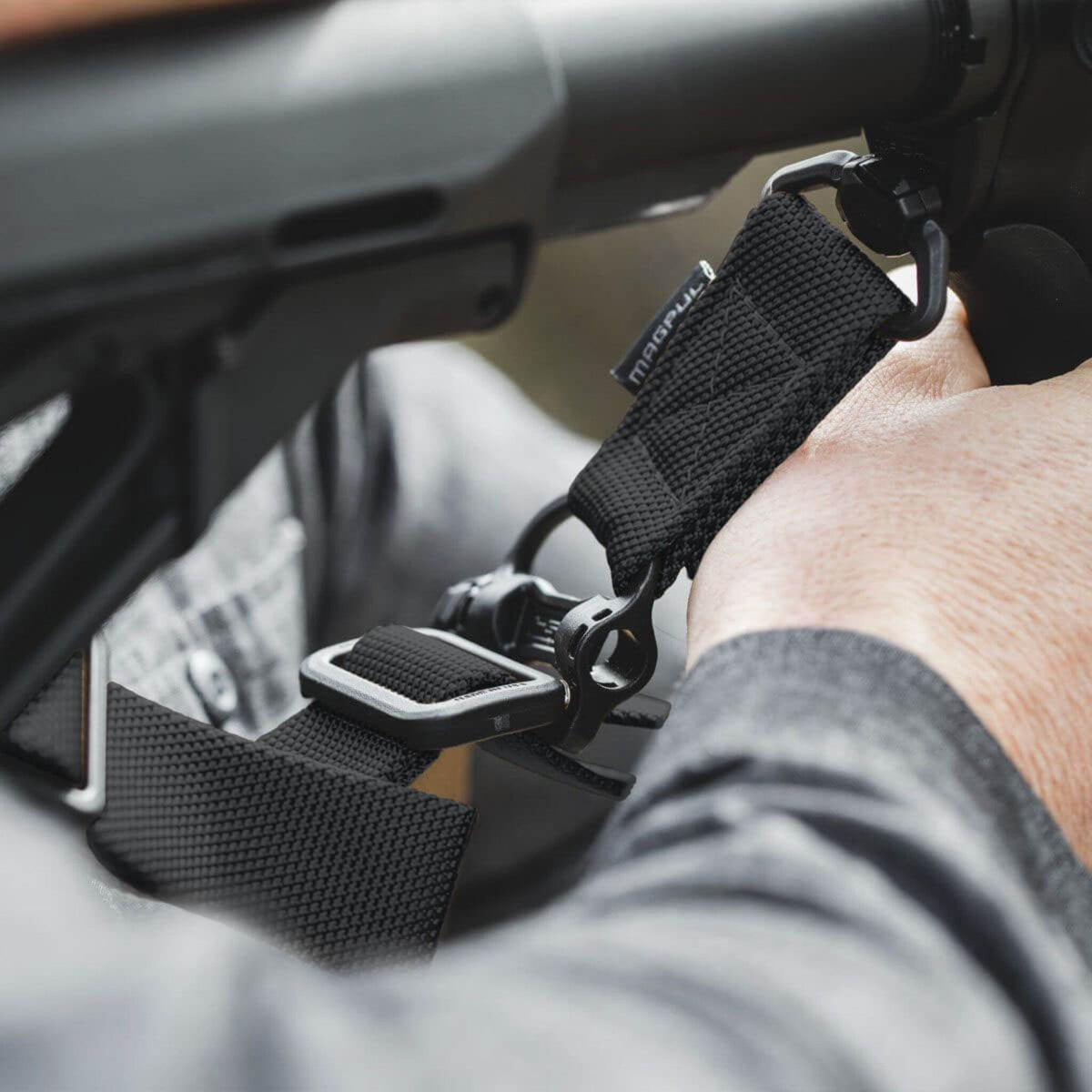 Magpul MS4 QDM Sling One-Point / Two-Point Rifle Sling, in use, sling being adjusted on a rifle