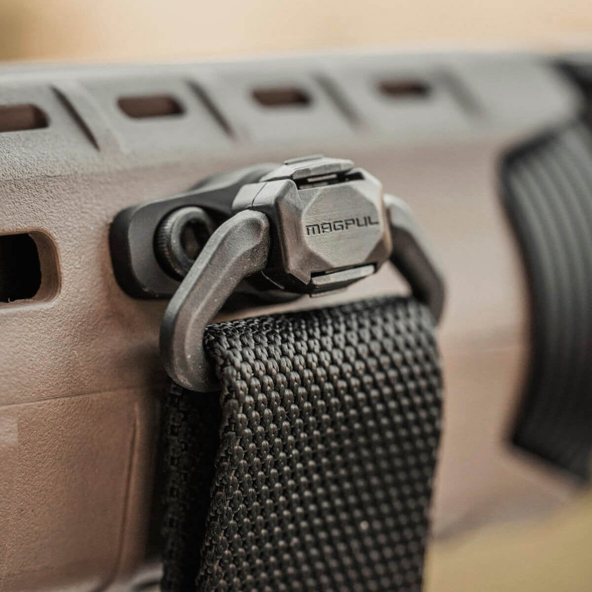 Magpul QDM Quick Disconnect Sling Swivel, fitted to an M-LOK handguard with a sling, close-up