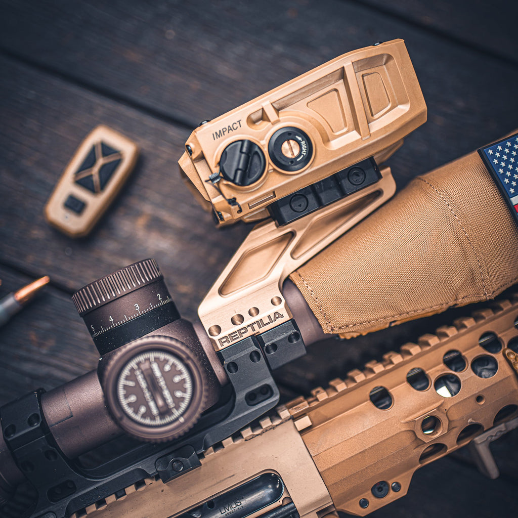 Reptilia ROF Diving Board 34mm fitted to a scope mount, in a flat lay with a scope and rifle parts