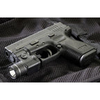 Streamlight TLR-3 light clamped to the accessory rail of a polymer-framed pistol